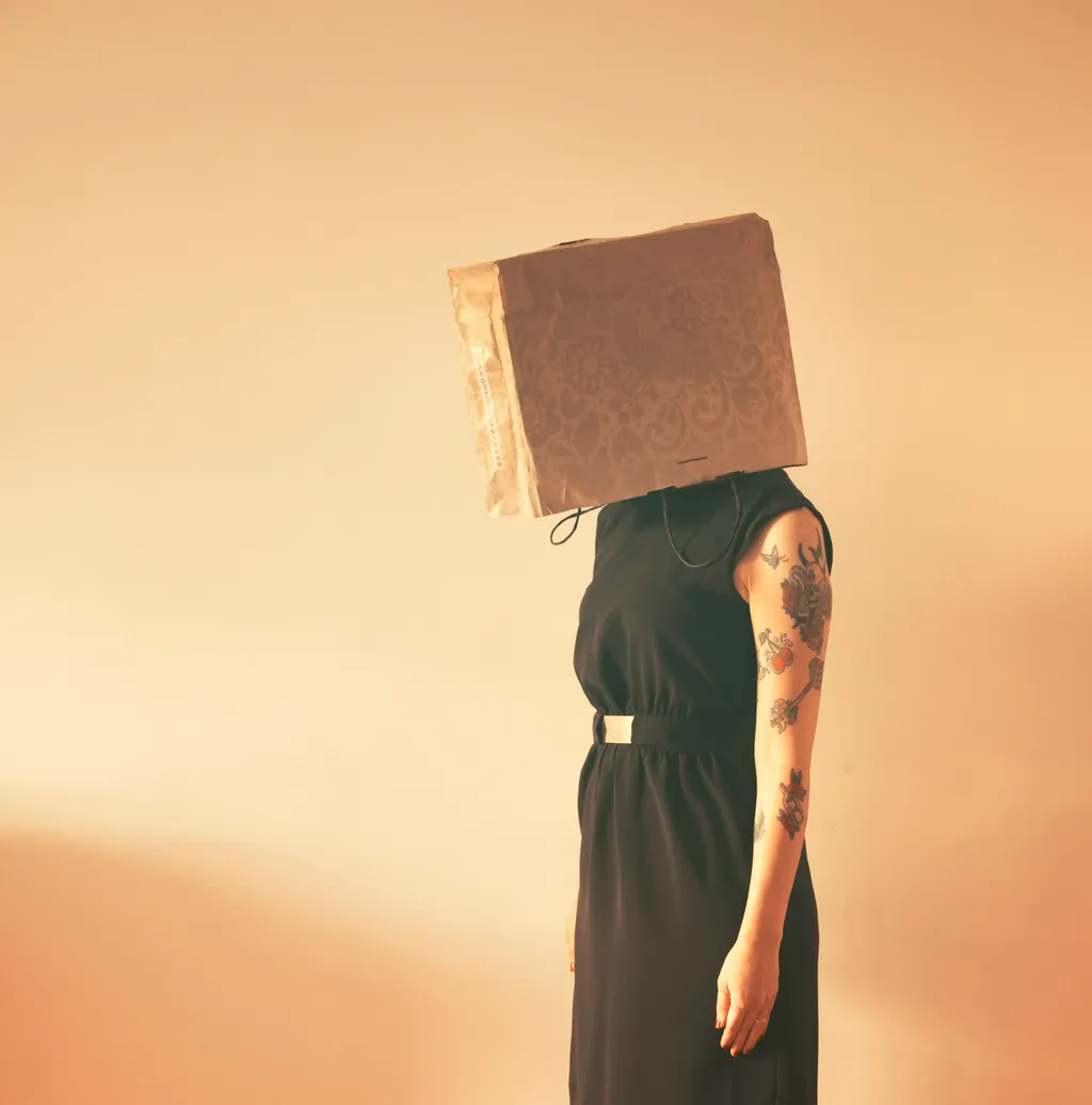 Woman with bag over head
