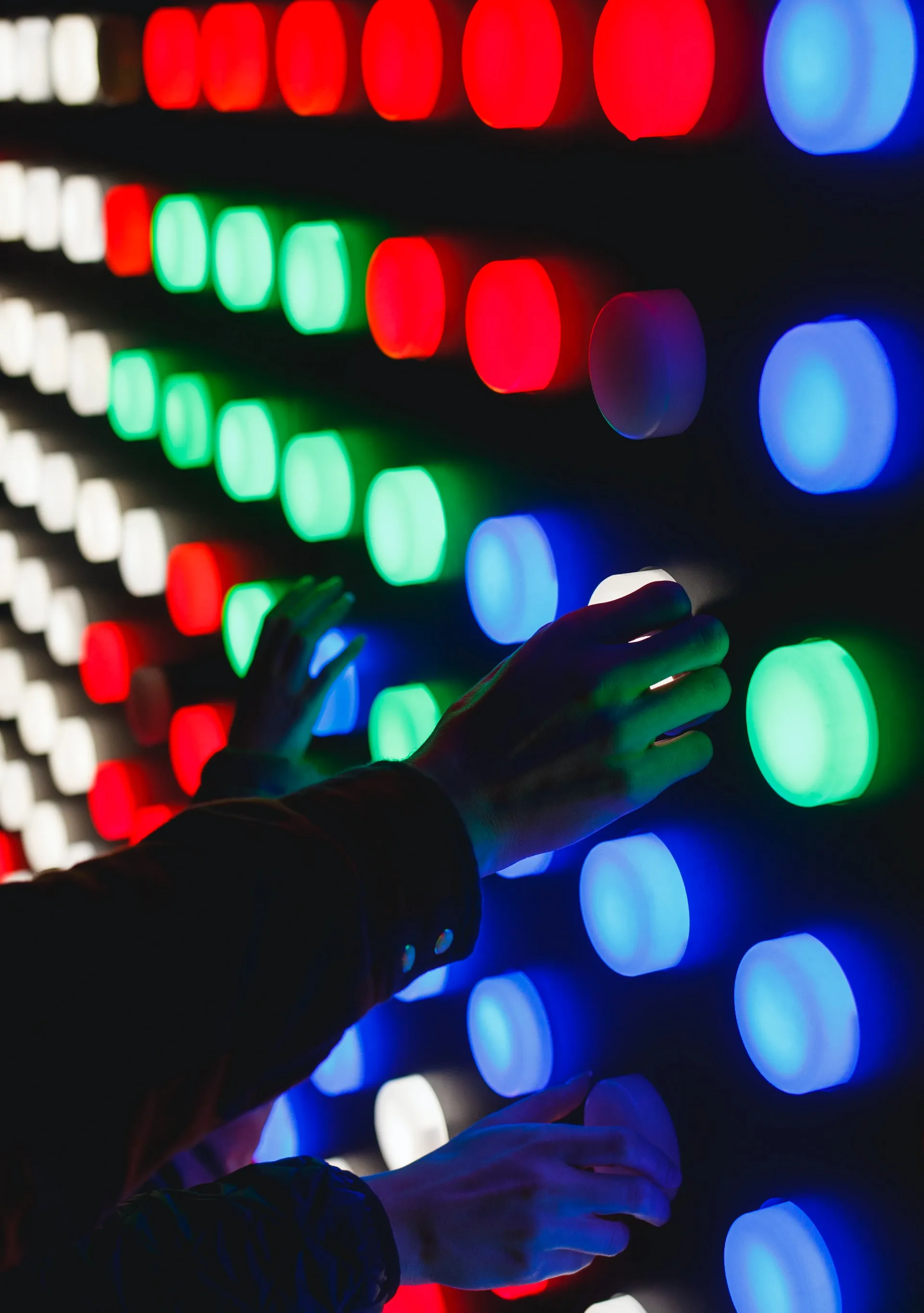 hands turning assorted color lights