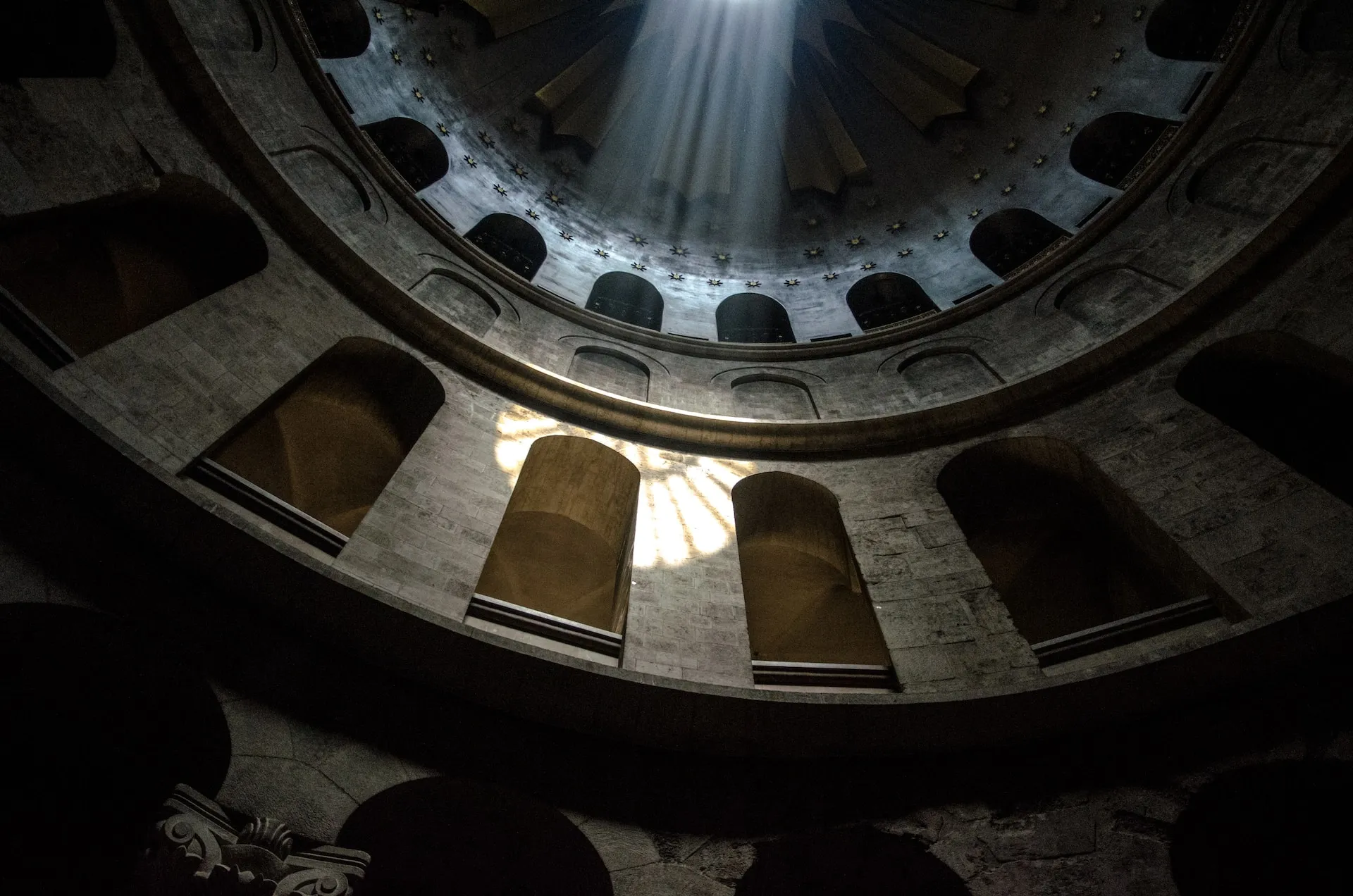 A light shines through the middle of a building